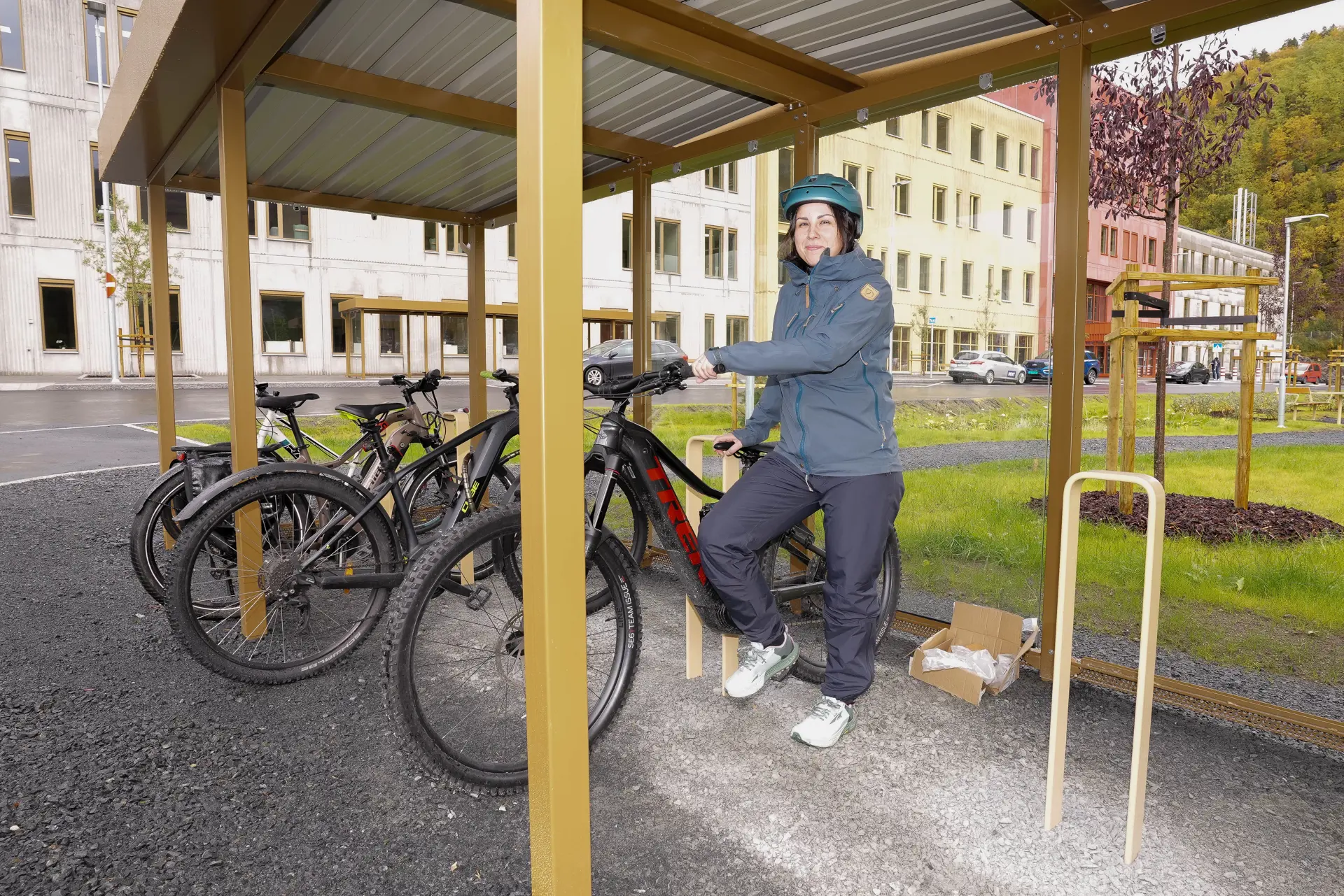 Dame som står med sin sykkel